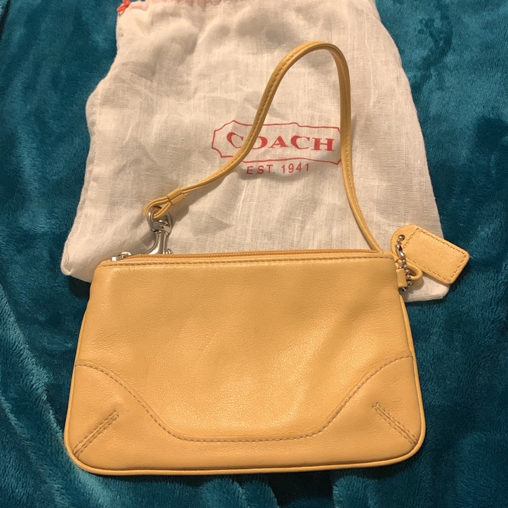 Small coach wristlet and dust bag see pictures for details